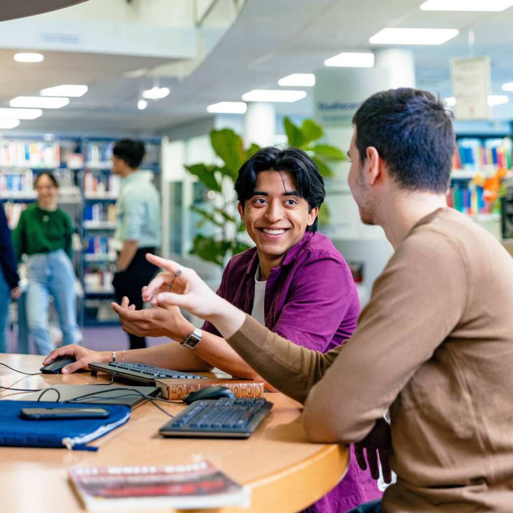 2 students in Applied Data Science working in the library.